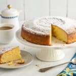 Traditional Vintage Swedish Cake Recipe with cardamom spicing, golden crust, and powdered sugar dusting on white cake stand