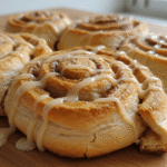 Tortilla Cinnamon Rolls topped with glaze on wooden table